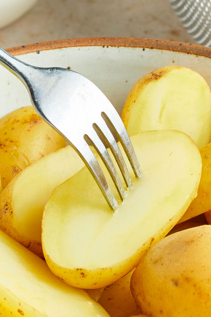 A fork piercing a potato