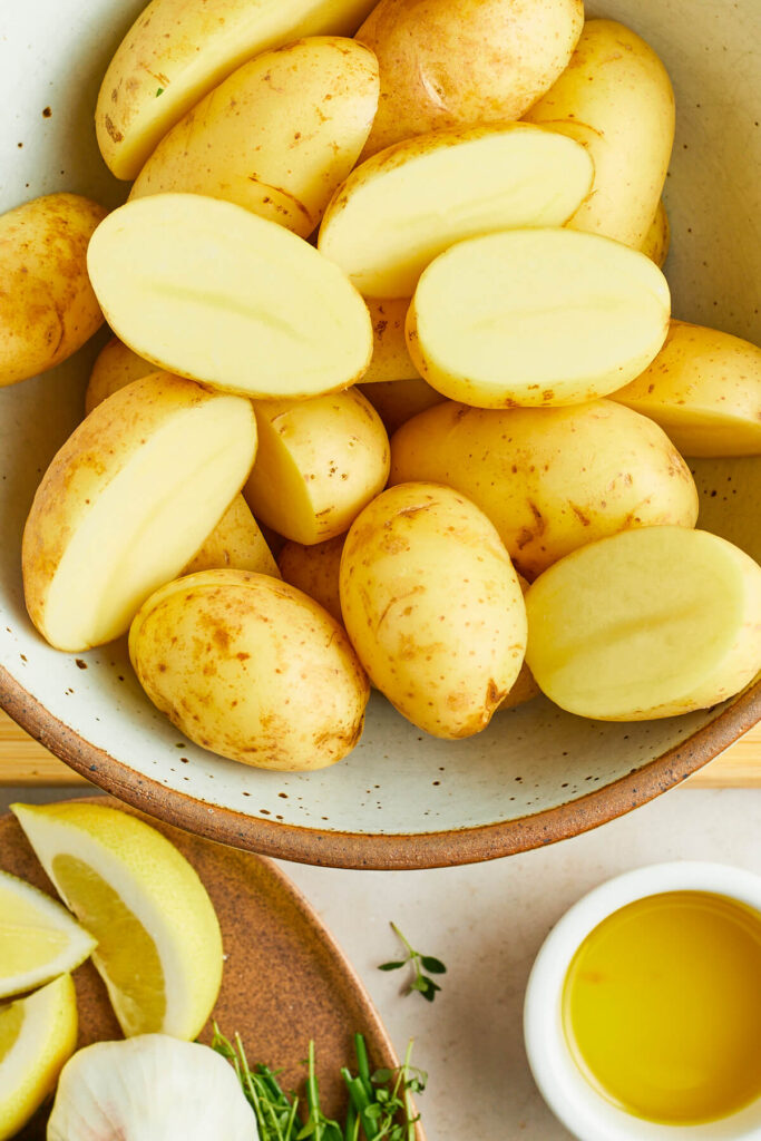 Halved gold potatoes in microwave-safe bowl
