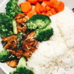 Saucy Sesame Soy Curls in a bowl with white rice, carrots, and broccoli