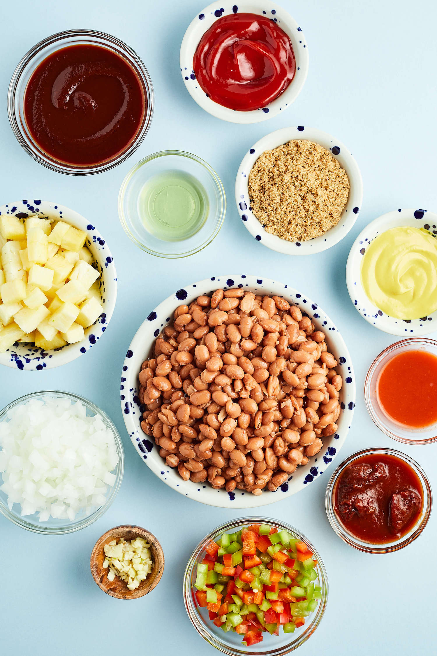 Baked Beans with Pineapple ingredients in bowls on blue table